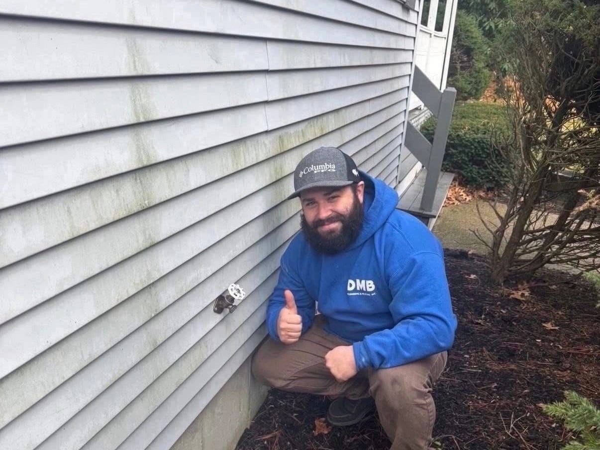 Dean Blanchard, owner of DMB Plumbing & Heating, in a royal blue DMB hoodie